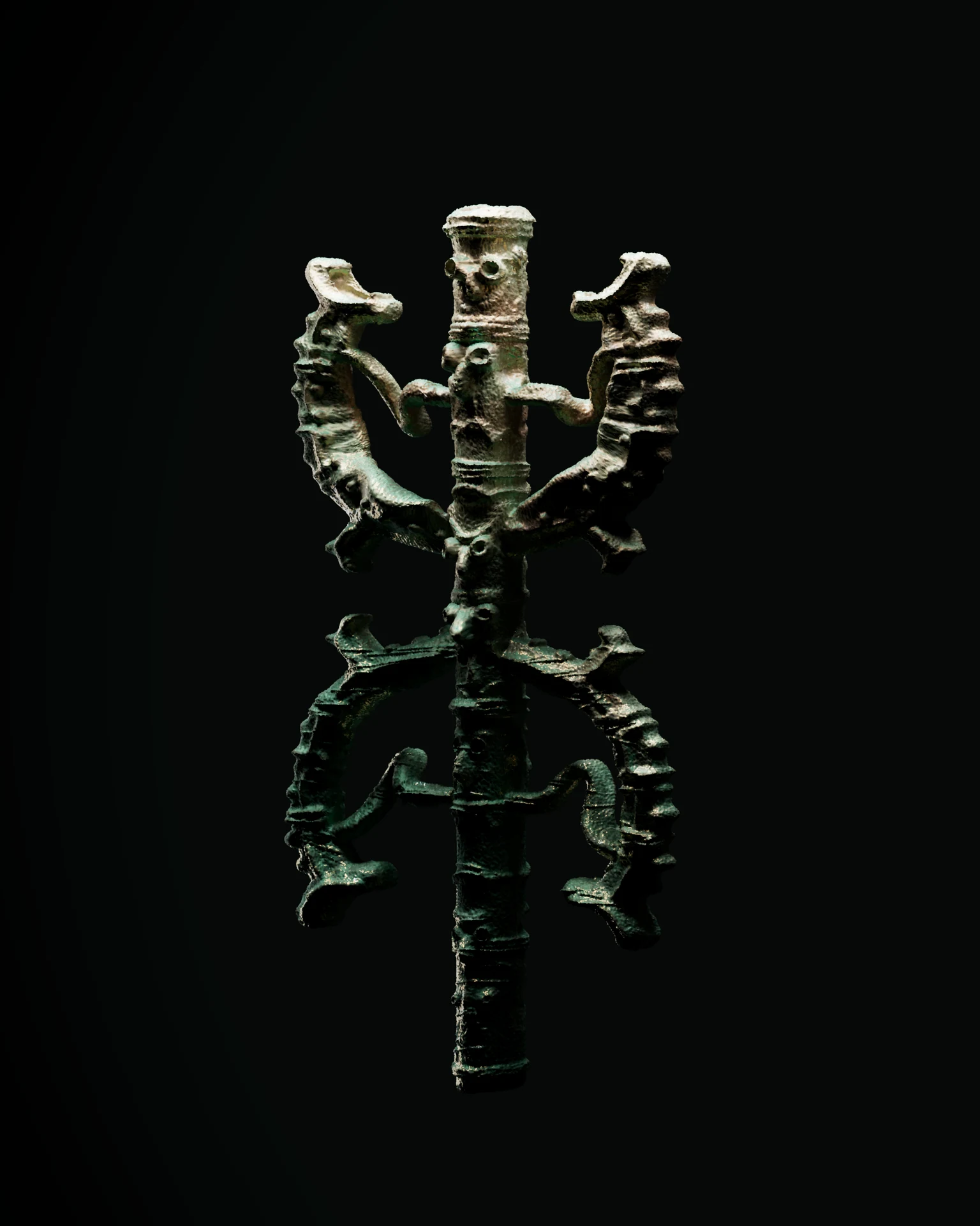 Dark sculptural figure against a black background